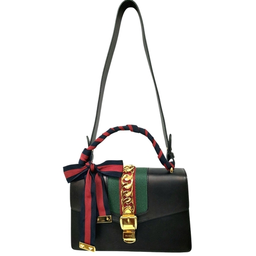 81 - A Gucci Black Calfskin Sylvie Bag. Black calfskin leather exterior with gold-toned hardware, featuri... 