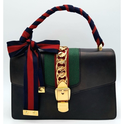 81 - A Gucci Black Calfskin Sylvie Bag. Black calfskin leather exterior with gold-toned hardware, featuri... 