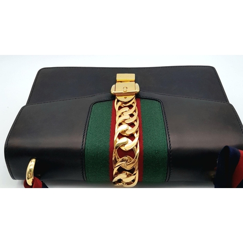 81 - A Gucci Black Calfskin Sylvie Bag. Black calfskin leather exterior with gold-toned hardware, featuri... 