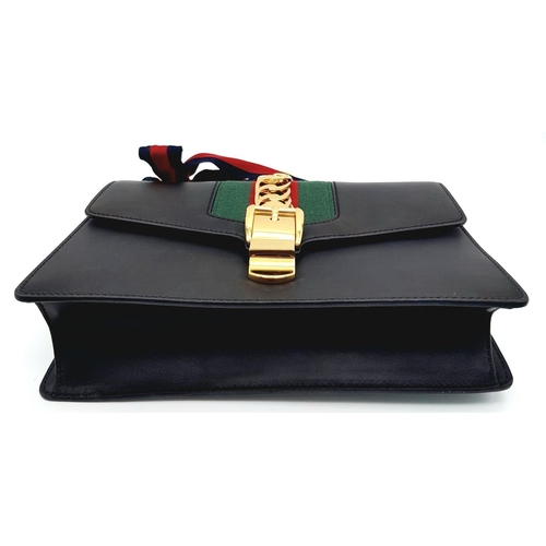 81 - A Gucci Black Calfskin Sylvie Bag. Black calfskin leather exterior with gold-toned hardware, featuri... 