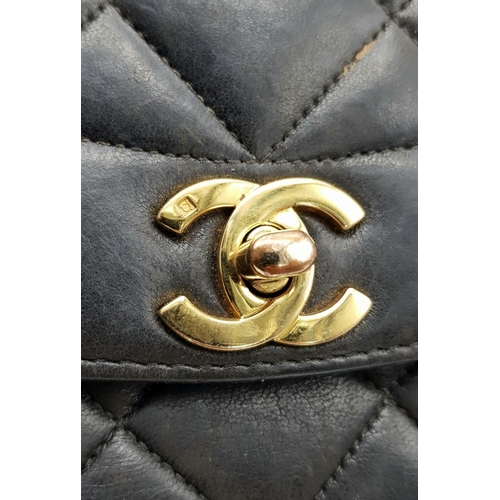 66 - A Chanel Black Quilted Flap Bag. Black leather exterior with gold-toned hardware, featuring the icon... 