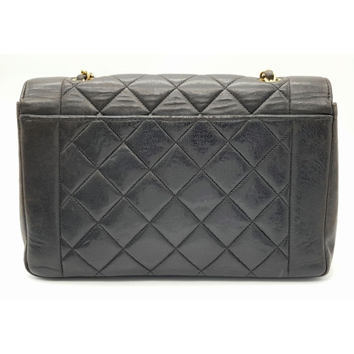 66 - A Chanel Black Quilted Flap Bag. Black leather exterior with gold-toned hardware, featuring the icon... 