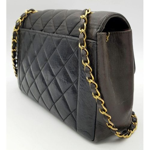 66 - A Chanel Black Quilted Flap Bag. Black leather exterior with gold-toned hardware, featuring the icon... 