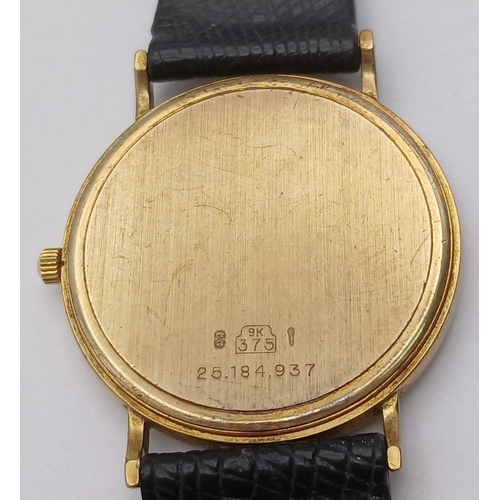 97 - A 9K Gold Cased Longine Quartz Gents Watch. Black leather strap. 9K gold case - 34mm. White dial wit... 