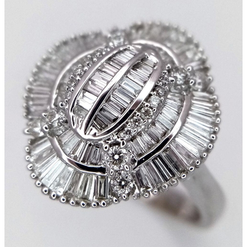 144 - An 18K White Gold and Diamond Dress Ring. 1ctw of round, baguette and tapered baguette diamonds. Stu... 