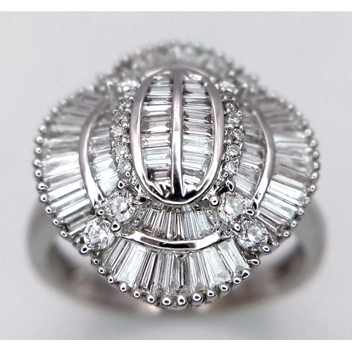 144 - An 18K White Gold and Diamond Dress Ring. 1ctw of round, baguette and tapered baguette diamonds. Stu... 