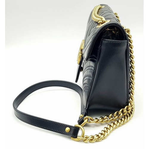 59 - A Gucci Black Marmont Matelassé Bag. Black quilted leather exterior with gold-toned hardware, chain ... 