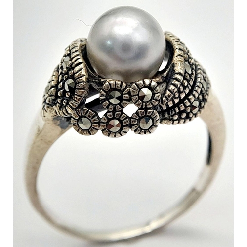 565 - A Vintage or Older Sterling Silver Pearl and Marcasite Set Ring Size Q. The Crown is set with an 8mm... 