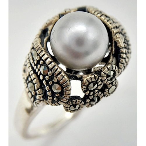 565 - A Vintage or Older Sterling Silver Pearl and Marcasite Set Ring Size Q. The Crown is set with an 8mm... 