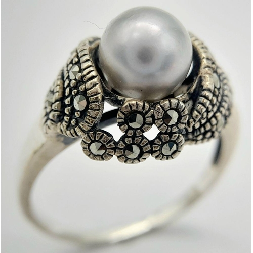 565 - A Vintage or Older Sterling Silver Pearl and Marcasite Set Ring Size Q. The Crown is set with an 8mm... 