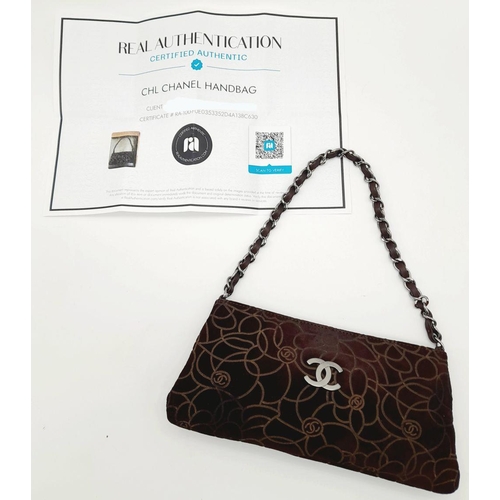 132 - A Chanel Brown Suede Camellia Clutch Bag. Brown suede exterior with Camellia floral motif detailing ... 