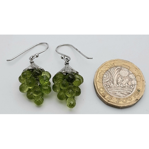 908 - A Unique Pair of Sterling Silver Peridot Set ‘Bacchus’ Design Earrings. 3.5cm Drop. 1.5cm Width.