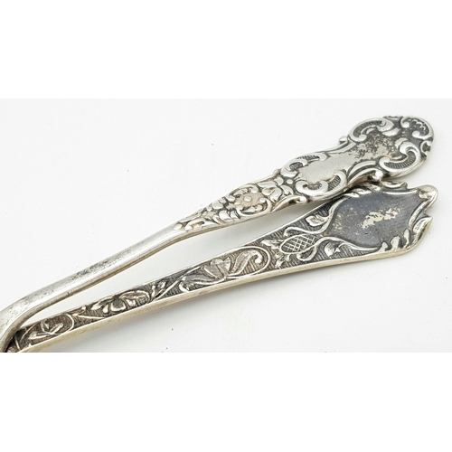 952 - Two Ornately Decorated Silver Teaspoons. Full hallmarked. 26.92g total weight.