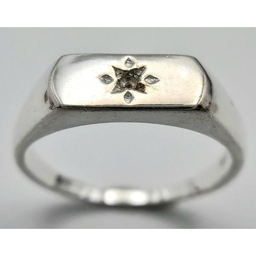 957 - A Sterling Siver Diamond Set Signet Ring Size N1/2. The Crown Measures 1.1 x 6mm. Set with a central... 
