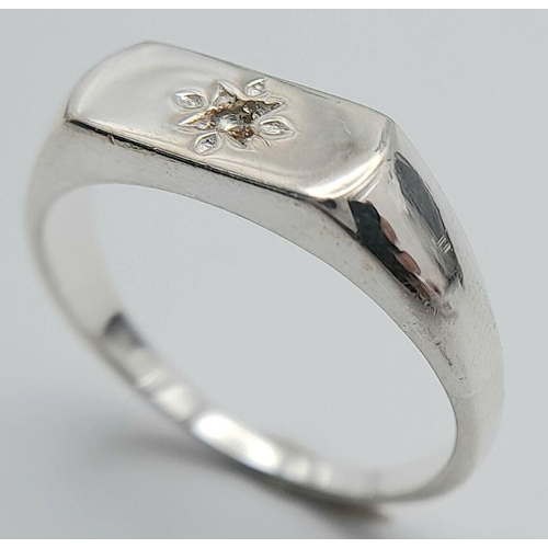 957 - A Sterling Siver Diamond Set Signet Ring Size N1/2. The Crown Measures 1.1 x 6mm. Set with a central... 