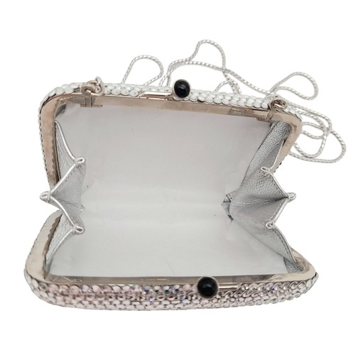 150 - A Judith Leiber Silver Rhinestone Mini Clutch Bag. Silver-tone rhinestone exterior with matching sil... 