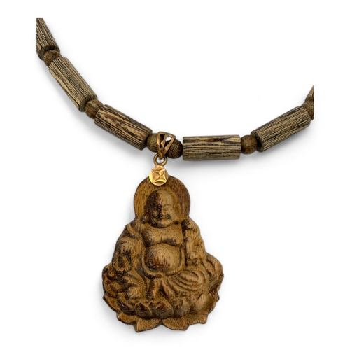 539 - An unique hand carved Agarwood Buddha Pendant on beaded Necklace. Agarwood beads in tubular and roun... 