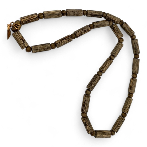 539 - An unique hand carved Agarwood Buddha Pendant on beaded Necklace. Agarwood beads in tubular and roun... 