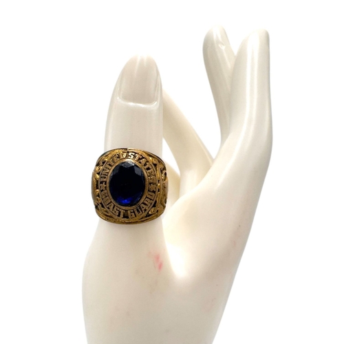 902 - A Vietnam war era US Coast Guard fraternity Ring, featuring a central dark blue oval stone and a sta... 