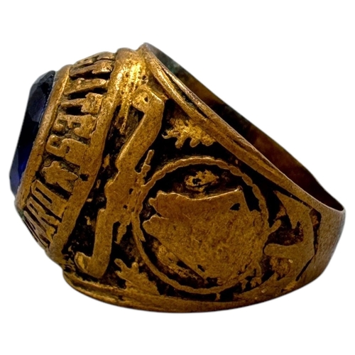 902 - A Vietnam war era US Coast Guard fraternity Ring, featuring a central dark blue oval stone and a sta... 
