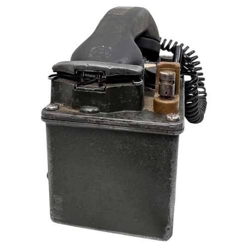 916 - A Vietnam war era US Army  H60/PT Military Field Telephone. Coiled cord connects the handset to the ... 