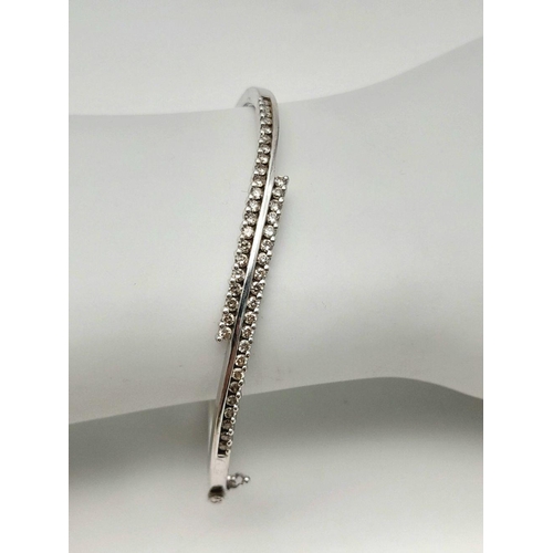 12 - A 9K White Gold and Diamond Crossover Bracelet. Two waves of diamonds create a stunning piece. Clip ... 