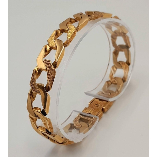 4 - A Chunky 9K Yellow Gold Curb Bracelet with Bark Effect Decoration. 18cm. 27g