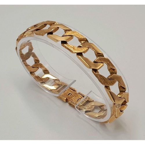 4 - A Chunky 9K Yellow Gold Curb Bracelet with Bark Effect Decoration. 18cm. 27g