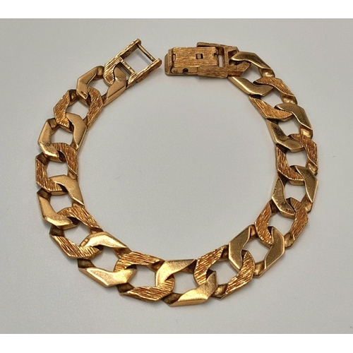 4 - A Chunky 9K Yellow Gold Curb Bracelet with Bark Effect Decoration. 18cm. 27g