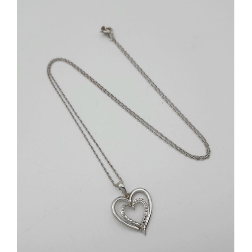 447 - A Sterling Silver and Diamond Heart Charm on a Sterling Silver Disappearing Necklace. 2cm and 44cm.