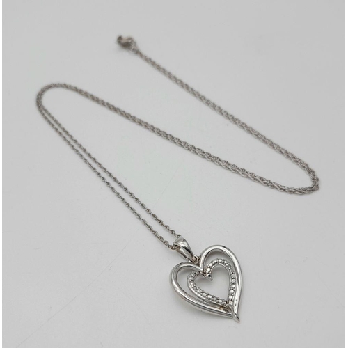 447 - A Sterling Silver and Diamond Heart Charm on a Sterling Silver Disappearing Necklace. 2cm and 44cm.