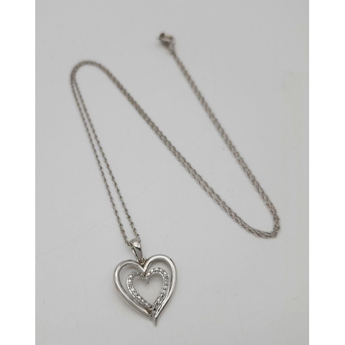 447 - A Sterling Silver and Diamond Heart Charm on a Sterling Silver Disappearing Necklace. 2cm and 44cm.