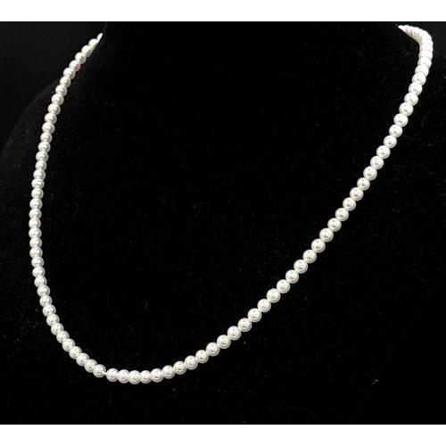 477 - A Cultured Pearl Bead Necklace with an 18K White Gold Clasp. Pearls 3/4mm. 40cm length. 8.2g total w... 