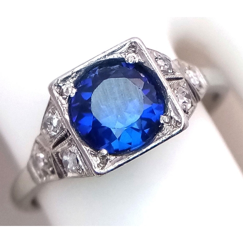 57 - An Art Deco 18K White Gold and Platinum, Sapphire and Diamond Ring. A mesmerising 1.5ct sapphire wit... 