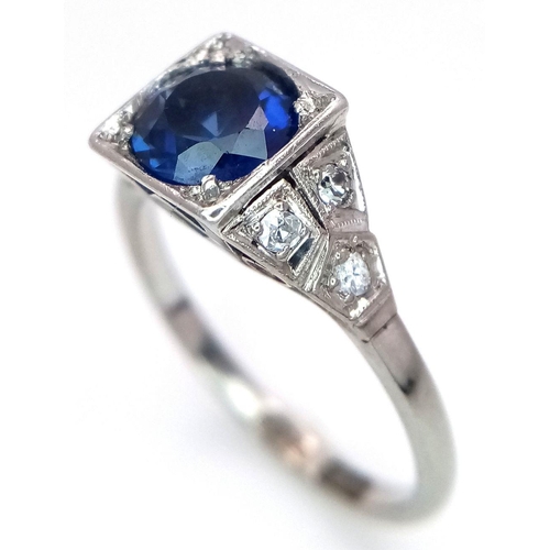 57 - An Art Deco 18K White Gold and Platinum, Sapphire and Diamond Ring. A mesmerising 1.5ct sapphire wit... 