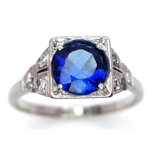 57 - An Art Deco 18K White Gold and Platinum, Sapphire and Diamond Ring. A mesmerising 1.5ct sapphire wit... 