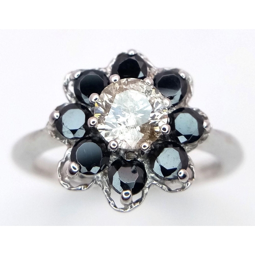 687 - A Vintage 9K White Gold, Diamond and Sapphire Ring. Central 0.75ct brilliant round cut diamond with ... 