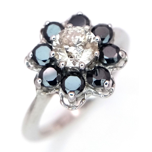 687 - A Vintage 9K White Gold, Diamond and Sapphire Ring. Central 0.75ct brilliant round cut diamond with ... 