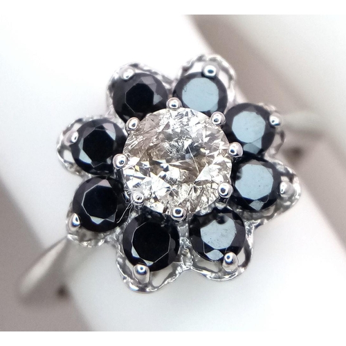 687 - A Vintage 9K White Gold, Diamond and Sapphire Ring. Central 0.75ct brilliant round cut diamond with ... 