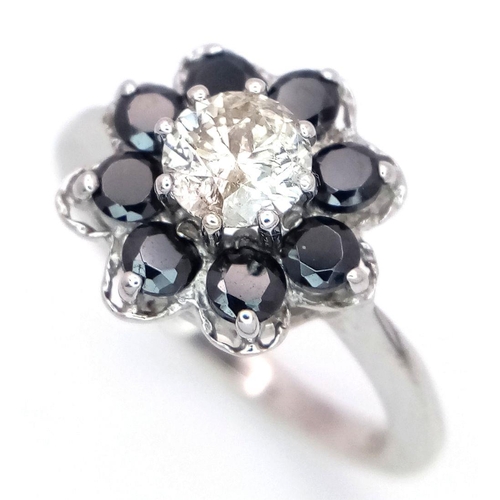 687 - A Vintage 9K White Gold, Diamond and Sapphire Ring. Central 0.75ct brilliant round cut diamond with ... 