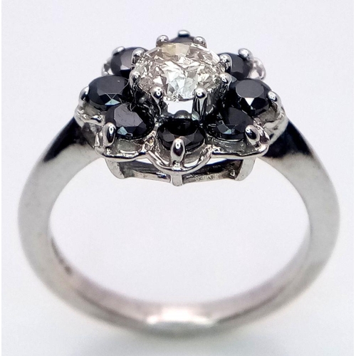 687 - A Vintage 9K White Gold, Diamond and Sapphire Ring. Central 0.75ct brilliant round cut diamond with ... 