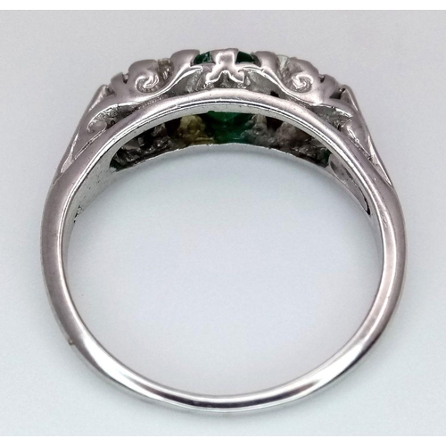 71 - An 18K White Gold Emerald and Diamond Ring. 0.50ct Emerald with diamond accents. Size M. 3.4g total ... 