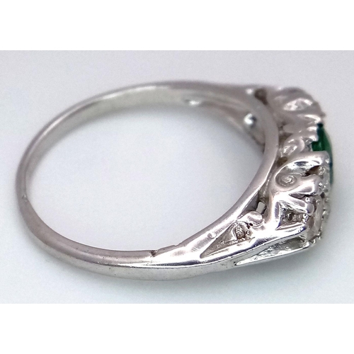 71 - An 18K White Gold Emerald and Diamond Ring. 0.50ct Emerald with diamond accents. Size M. 3.4g total ... 