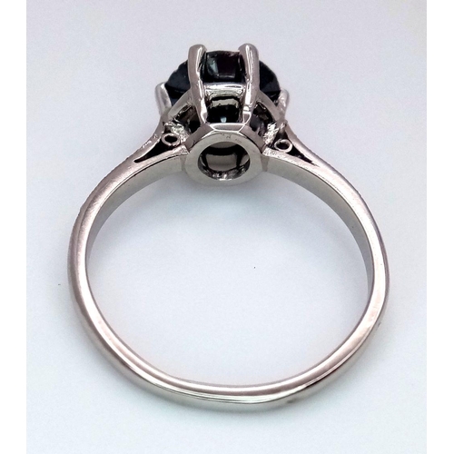 72 - A Platinum and Black Diamond Ring. 1.5ct round cut diamond with white diamond accents. Size L. 3.3g ... 