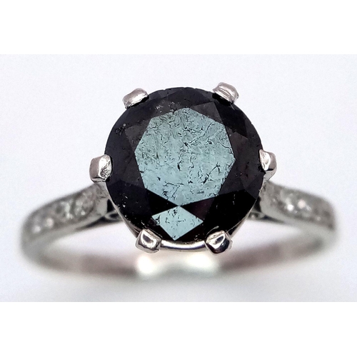 72 - A Platinum and Black Diamond Ring. 1.5ct round cut diamond with white diamond accents. Size L. 3.3g ... 