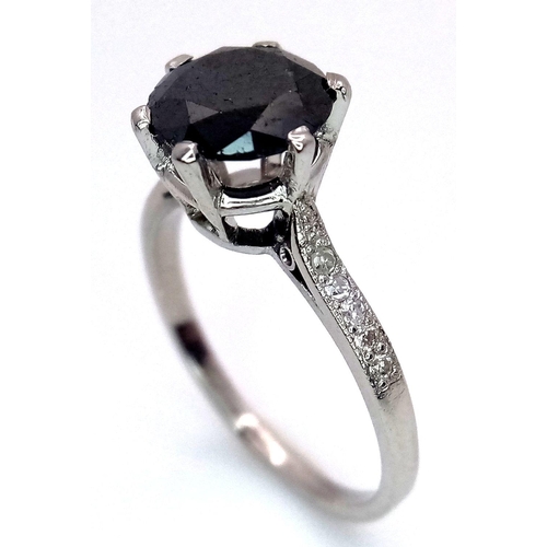 72 - A Platinum and Black Diamond Ring. 1.5ct round cut diamond with white diamond accents. Size L. 3.3g ... 