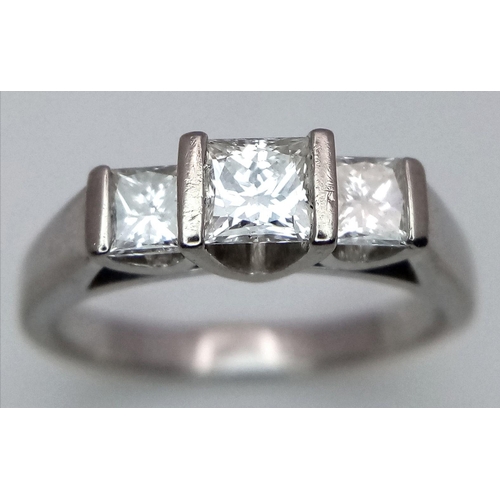 85 - An 18K White Gold Three Stone Diamond Ring. 0.80ctw of Princess cut diamonds - SI1 clarity. Size L. ... 