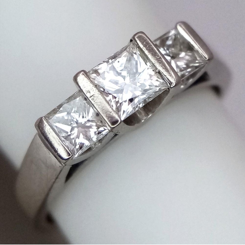 85 - An 18K White Gold Three Stone Diamond Ring. 0.80ctw of Princess cut diamonds - SI1 clarity. Size L. ... 