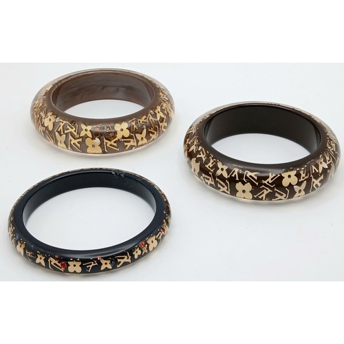 949 - Three Decorative Louis Vuitton Dress Bangles. 10mm and 2 x 22mm widths. 64mm inner diameters. Monogr... 