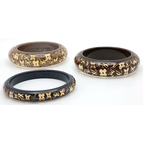 949 - Three Decorative Louis Vuitton Dress Bangles. 10mm and 2 x 22mm widths. 64mm inner diameters. Monogr... 